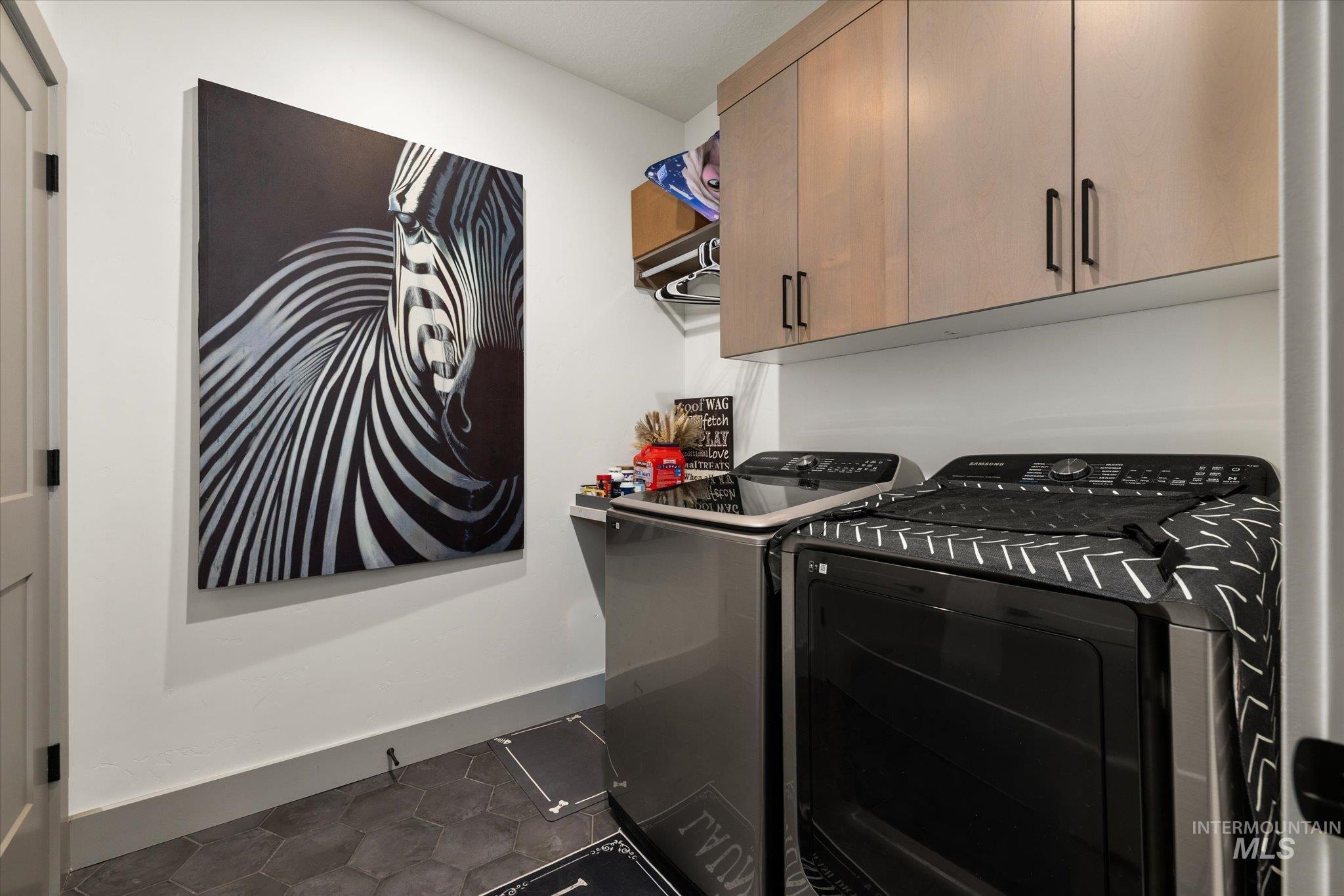 2250 South Steichen Way Meridian, ID 83642 - Photo 26 of 40 Laundry room with cabinet space, washer and dryer, and dark tile patterned flooring