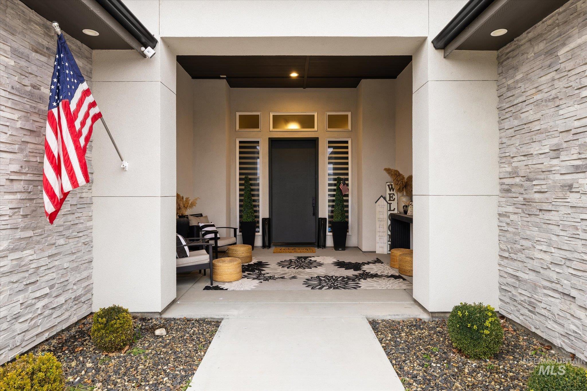 2250 South Steichen Way Meridian, ID 83642 - Photo 3 of 40 Property entrance featuring stucco siding and a porch