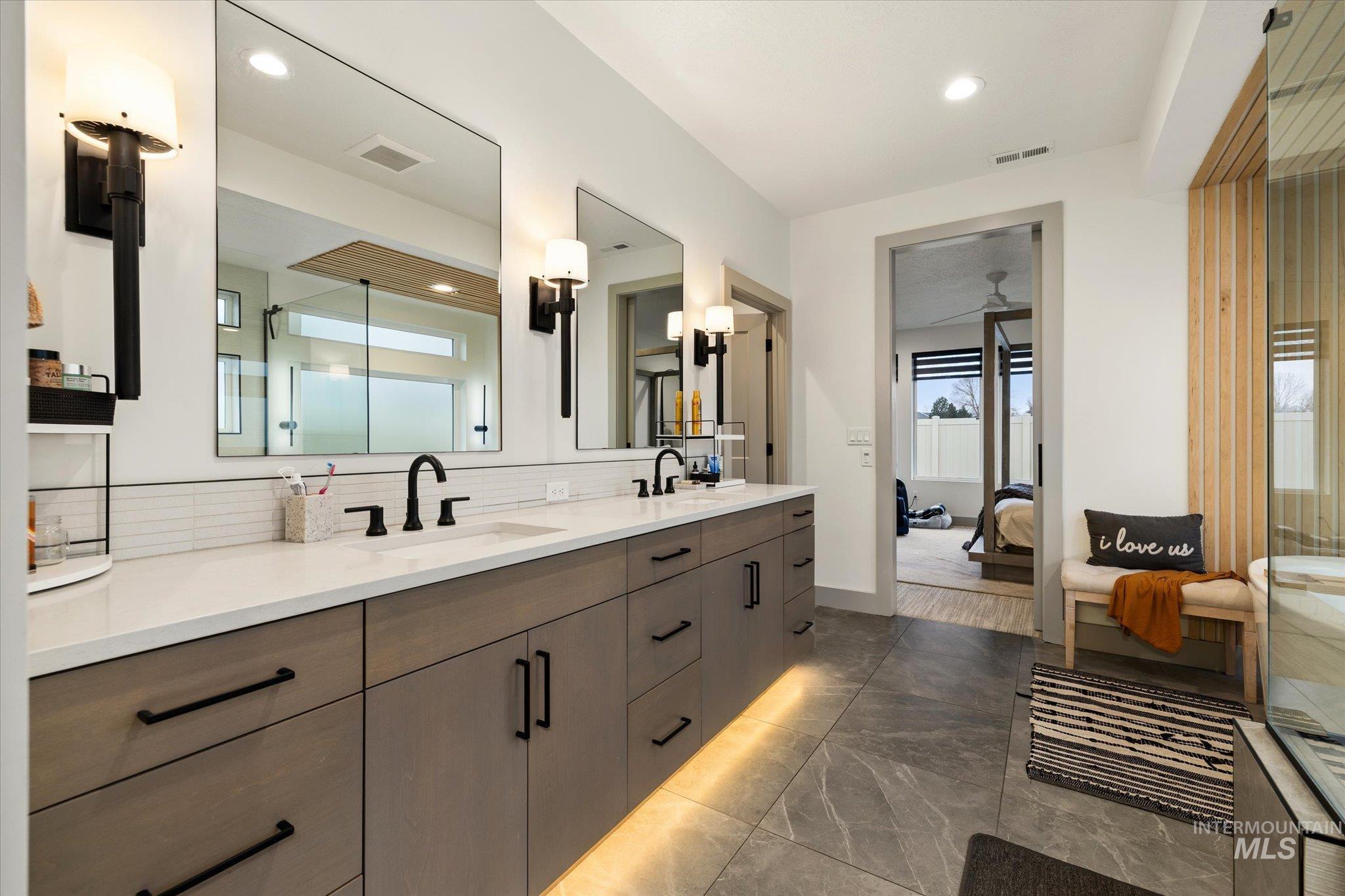 2250 South Steichen Way Meridian, ID 83642 - Photo 33 of 40 Bathroom featuring double vanity, tasteful backsplash, a shower stall, ensuite bathroom, and dark marble finish floors
