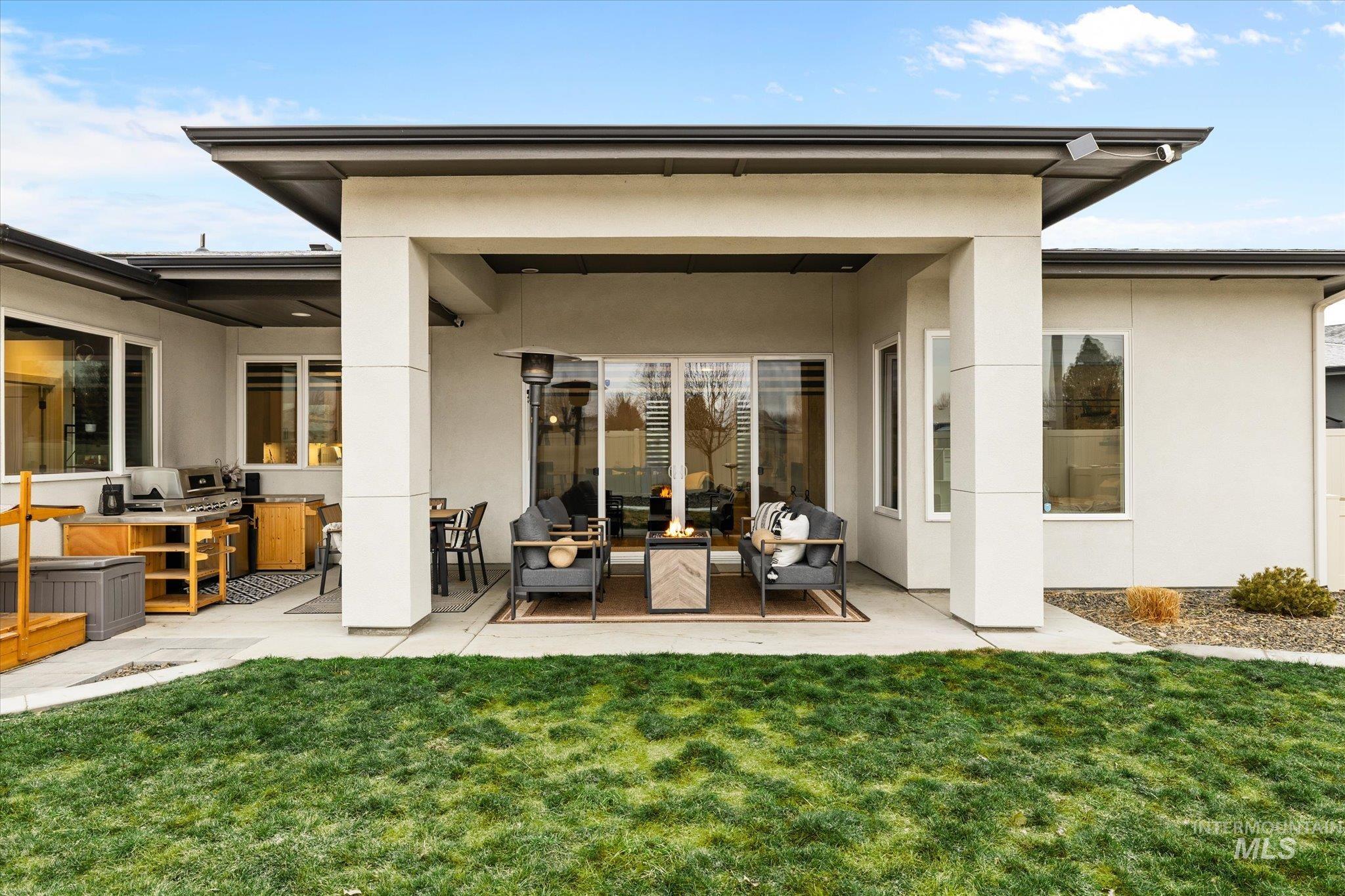 2250 South Steichen Way Meridian, ID 83642 - Photo 35 of 40 Rear view of property with a patio, a yard, and stucco siding