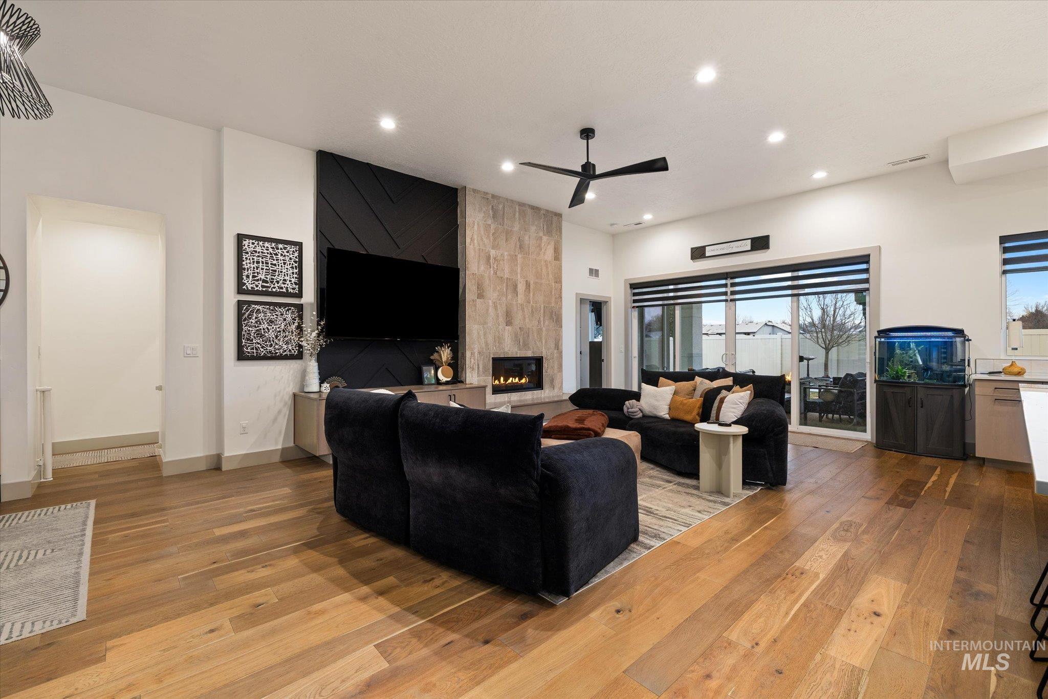2250 South Steichen Way Meridian, ID 83642 - Photo 5 of 40 Living area with recessed lighting, ceiling fan, light wood finished floors, and a tiled fireplace