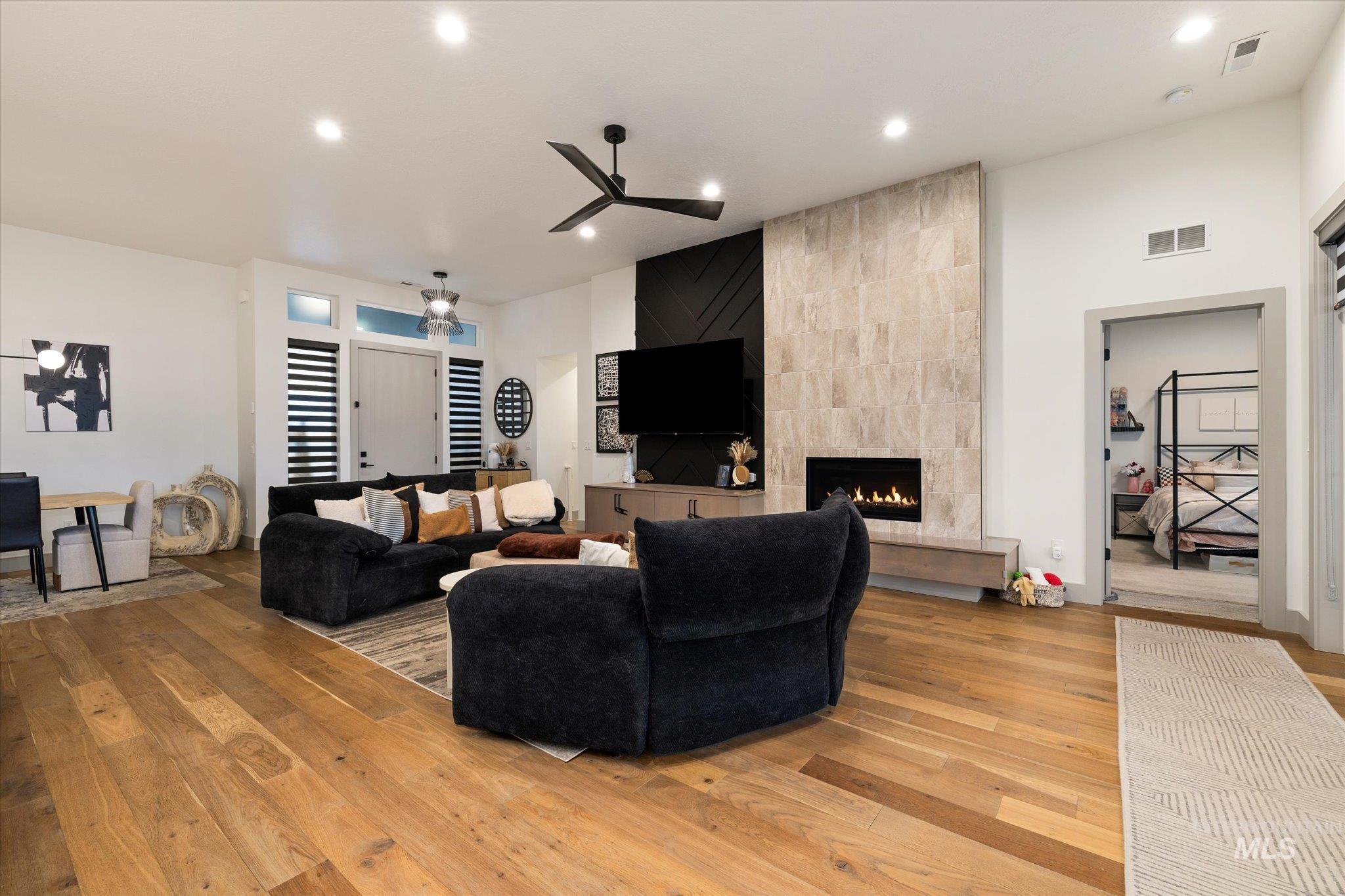 2250 South Steichen Way Meridian, ID 83642 - Photo 7 of 40 Living room featuring a tile fireplace, hardwood / wood-style floors, a ceiling fan, and recessed lighting