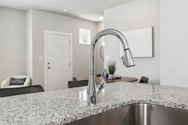 a kitchen with granite countertop a sink and dishwasher with wooden floor