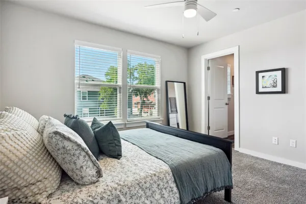 a spacious bedroom with a bed and a cabinets