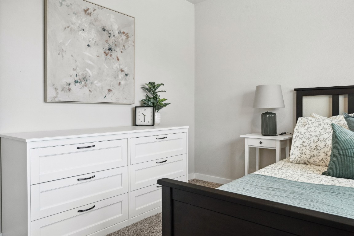 523 Powell Drive, Unit 1101 Leander, TX 78641 - Photo 21 of 24 Bedroom featuring baseboards and light colored carpet