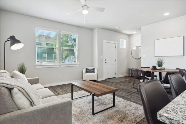 a living room with furniture a rug and a window