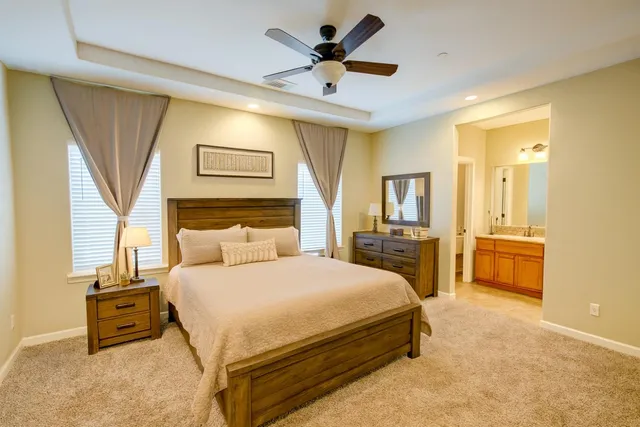 a bedroom with a bed and a chandelier