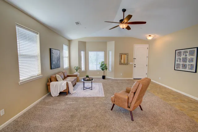 a living room with furniture and a large window