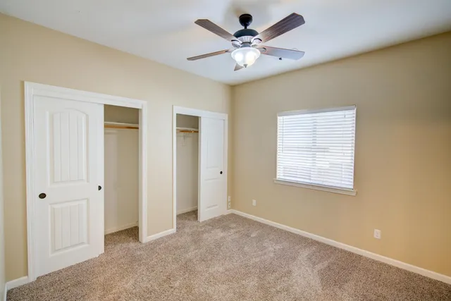 a view of a livingroom with a chandelier fan