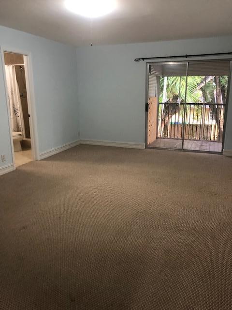 8978 West Sample Road, Unit 203 Coral Springs, FL 33065 - Photo 12 of 13 an empty room with an outdoor view and a window