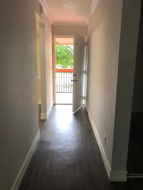 8978 West Sample Road, Unit 203 Coral Springs, FL 33065 - Photo 2 of 13 a view of a hallway with wooden floor