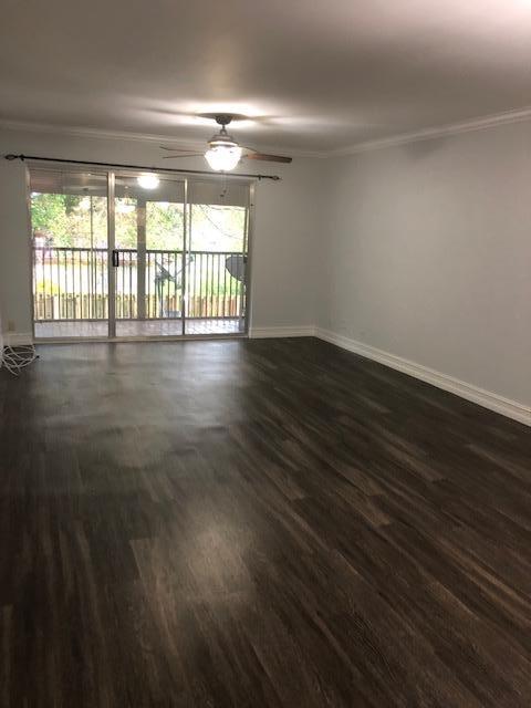 8978 West Sample Road, Unit 203 Coral Springs, FL 33065 - Photo 6 of 13 wooden floor in an empty room with a window