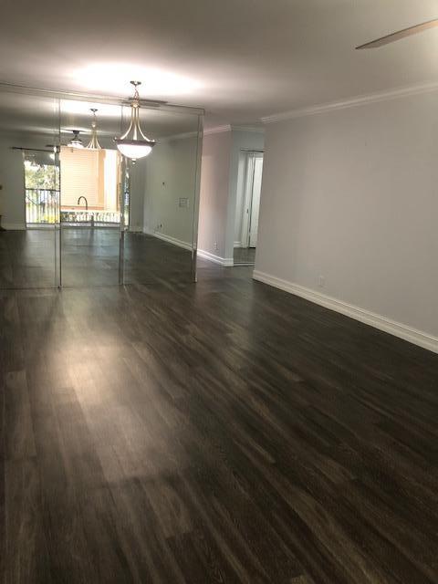 8978 West Sample Road, Unit 203 Coral Springs, FL 33065 - Photo 7 of 13 an empty room with wooden floor