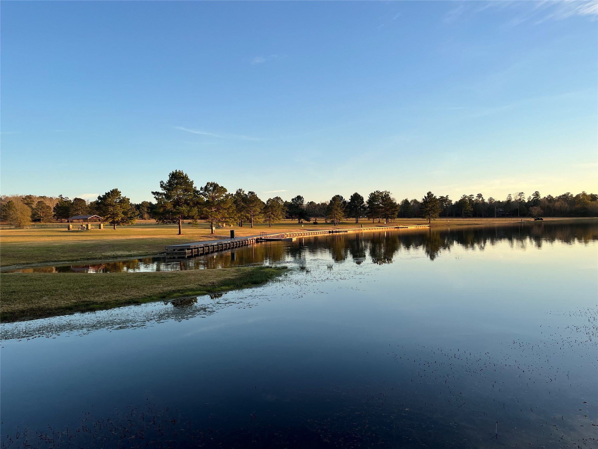 12696 Oak Barrel Road Willis, TX 77378 - Photo 17 of 19 a view of a lake with houses in the background