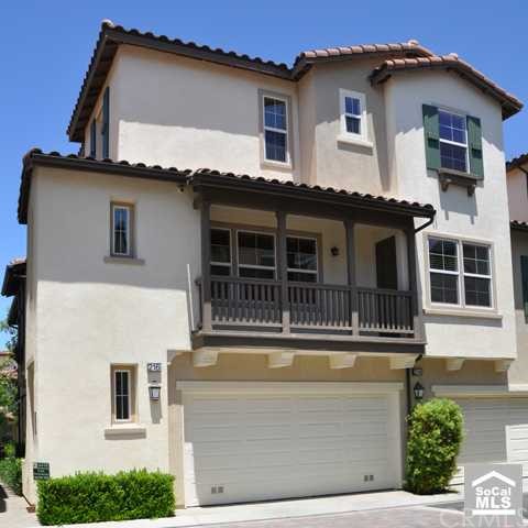 View of the home with charming balcony