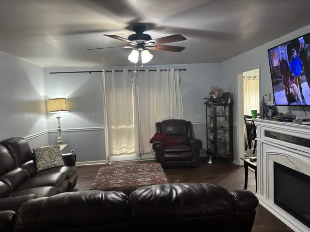 a living room with furniture a fireplace and a flat screen tv