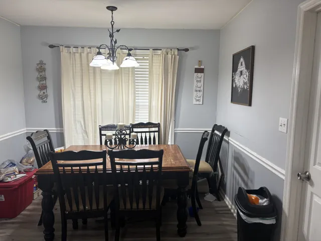 a view of a dining room with furniture and window