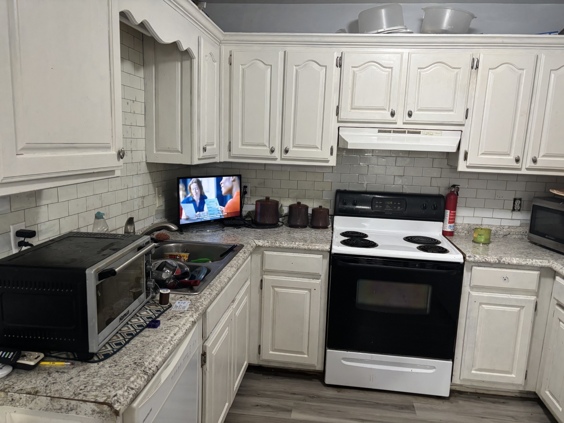 2892 Dodson Gap Road Culleoka, TN 38451 - Photo 6 of 13 a kitchen with granite countertop white cabinets and white appliances