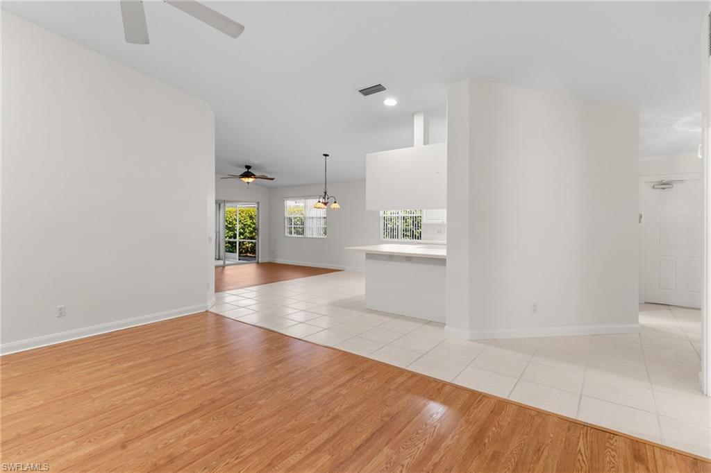 4907 Kingston Way Naples, FL 34119 - Photo 11 of 49 a view of empty room with wooden floor