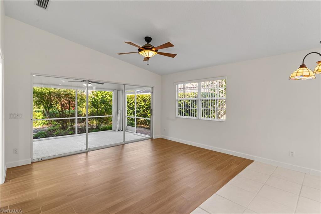 4907 Kingston Way Naples, FL 34119 - Photo 12 of 49 wooden floor in an empty room with a window