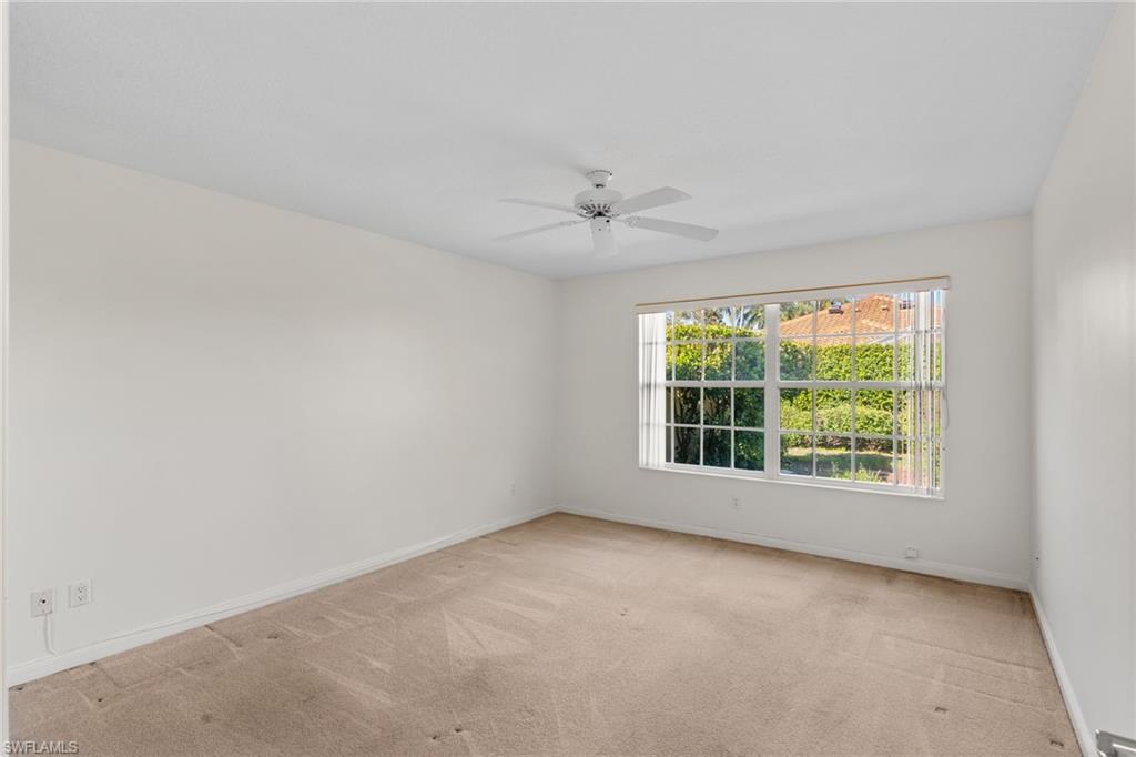 4907 Kingston Way Naples, FL 34119 - Photo 16 of 49 an empty room with a window and a ceiling fan