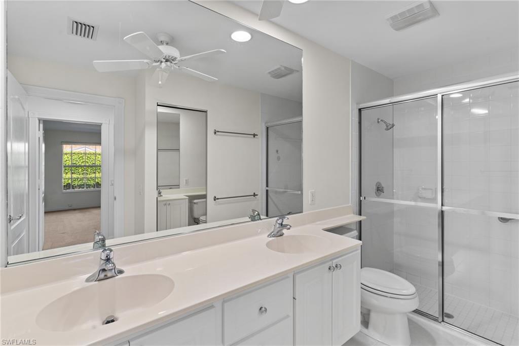 4907 Kingston Way Naples, FL 34119 - Photo 19 of 49 a bathroom with a sink toilet and shower