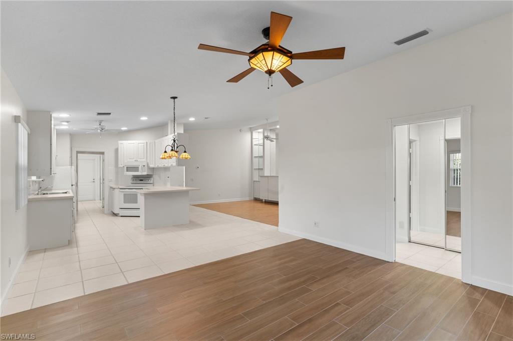 4907 Kingston Way Naples, FL 34119 - Photo 27 of 49 a view of an empty room and kitchen view