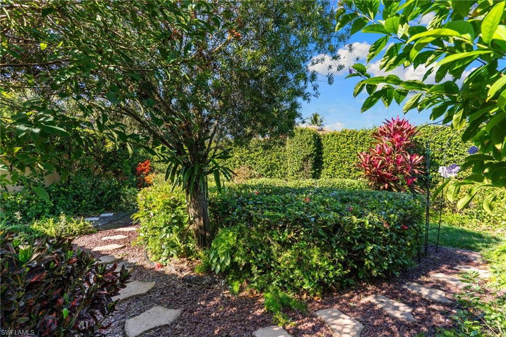 4907 Kingston Way Naples, FL 34119 - Photo 29 of 49 a view of a garden with plants and large trees
