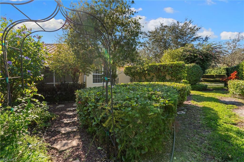 4907 Kingston Way Naples, FL 34119 - Photo 30 of 49 a backyard of a house with lots of green space