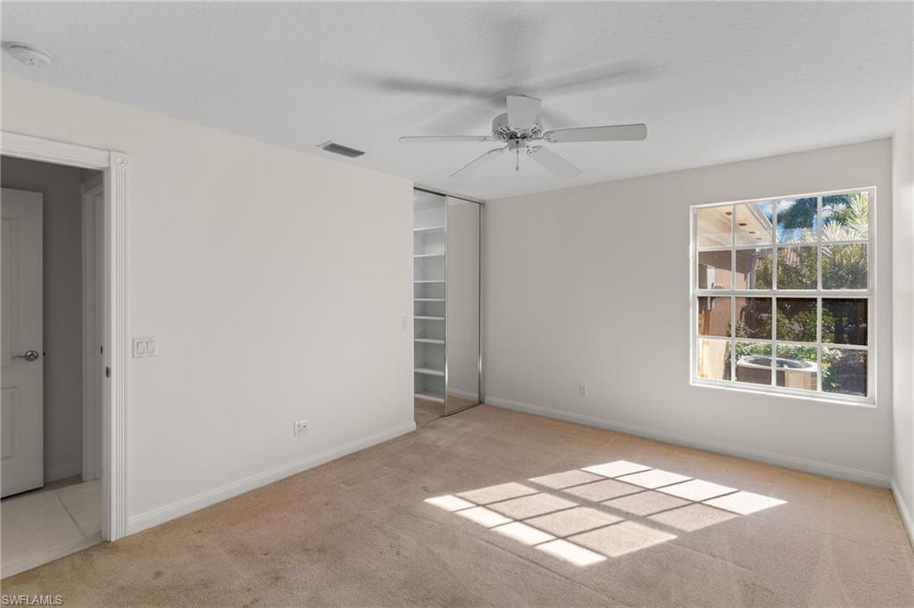 4907 Kingston Way Naples, FL 34119 - Photo 32 of 49 an empty room with windows and fan