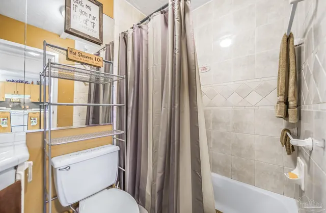 a bathroom with a toilet and a shower