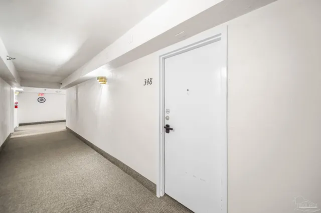 a livingroom with table and a potted plant