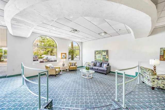 a lobby with furniture and a large window