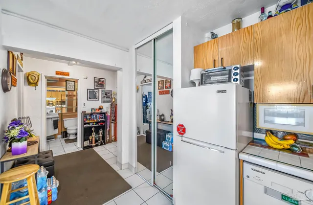 a white refrigerator freezer sitting inside of a kitchen