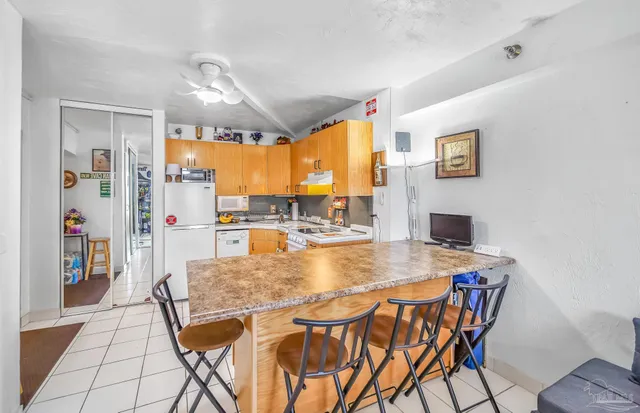 a view of a dining room with furniture and a chandelier