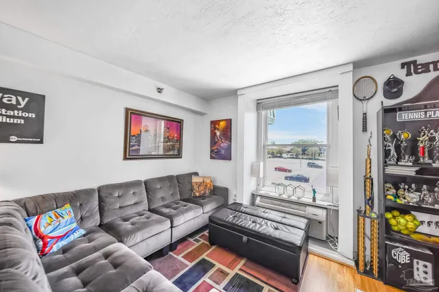 a living room with furniture cabinets and window