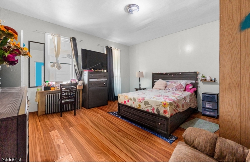 509 Marshall Street, Unit 2 Elizabeth Port, NJ 07206 - Photo 17 of 21 a bedroom with a bed and a television