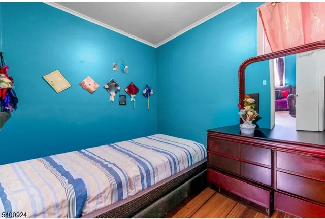 a bedroom with a bed and a mirror