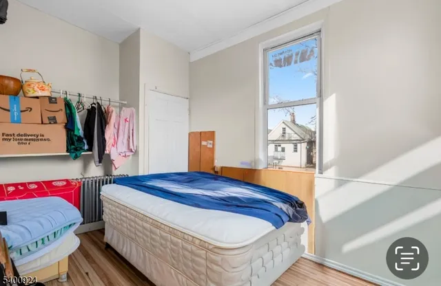 a bedroom with a bed and a window