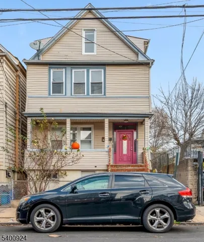 a front view of a house with parking space