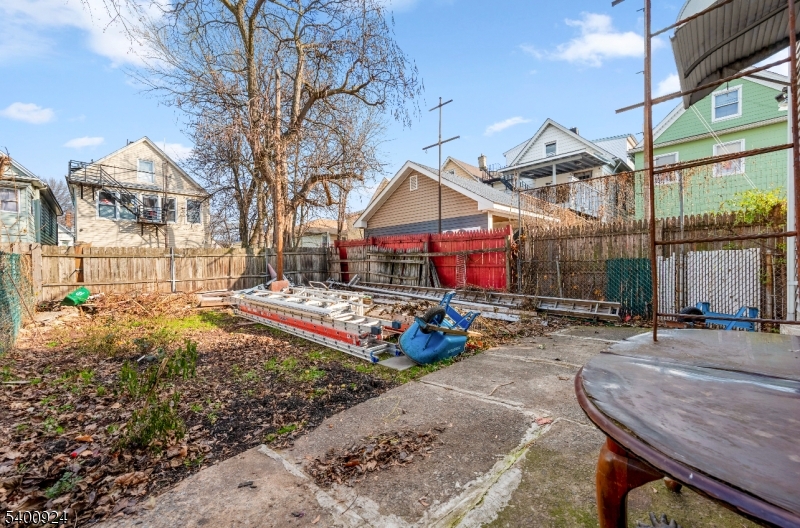 509 Marshall Street, Unit 2 Elizabeth Port, NJ 07206 - Photo 21 of 21 a view of a white house with a small yard and large trees