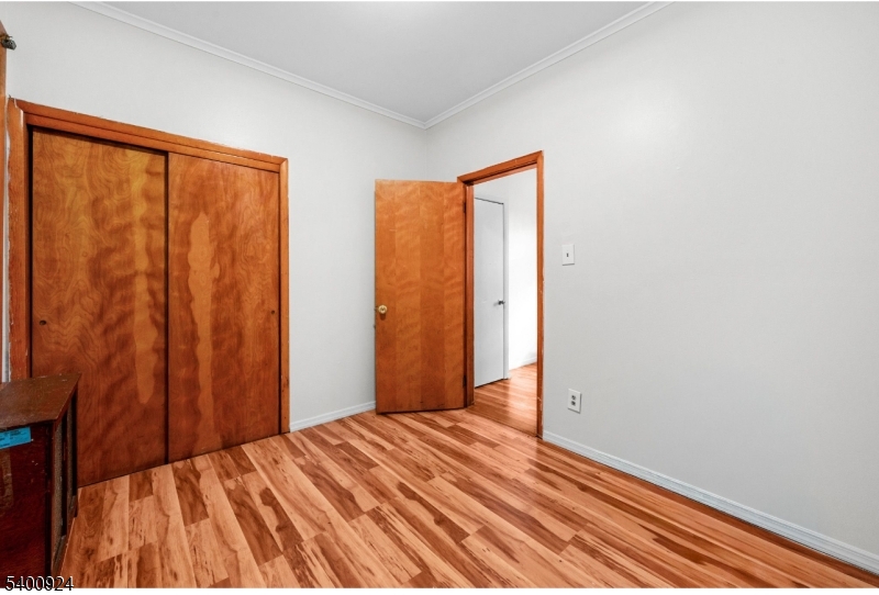 509 Marshall Street, Unit 2 Elizabeth Port, NJ 07206 - Photo 6 of 21 a bedroom with a bed and wooden floor