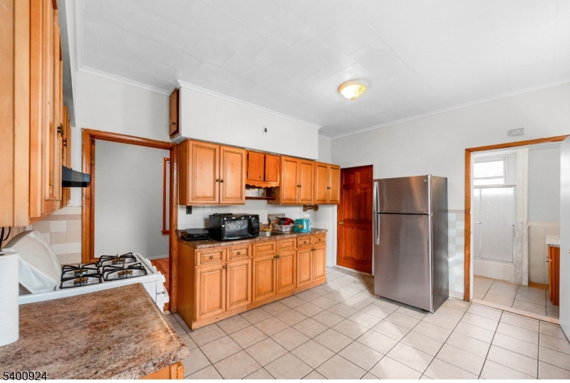 509 Marshall Street, Unit 2 Elizabeth Port, NJ 07206 - Photo 7 of 21 a kitchen with stainless steel appliances granite countertop a refrigerator and a stove