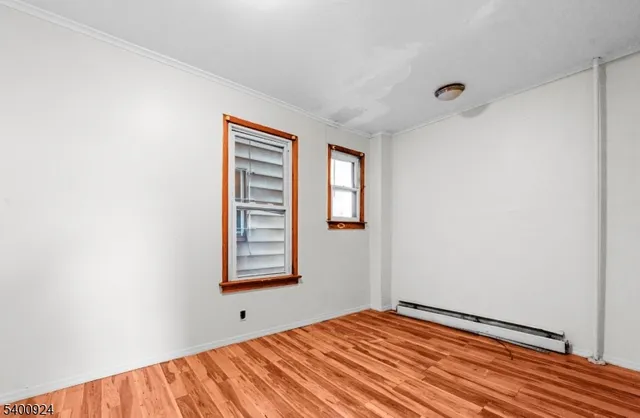 a view of a room with wooden floor and window