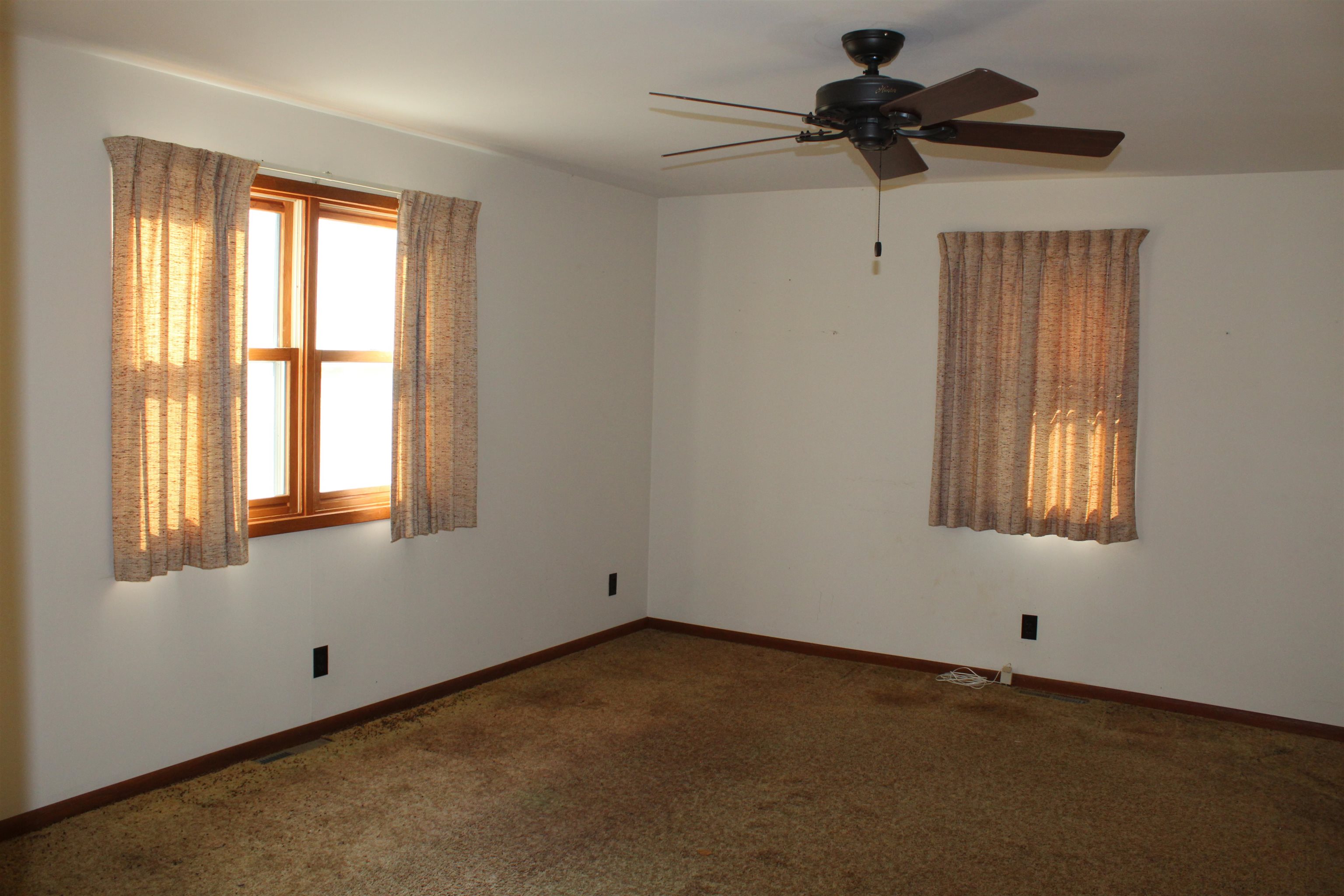 a view of an empty room and a window