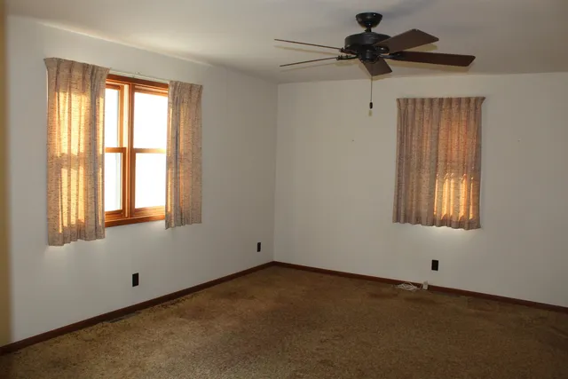 a view of an empty room and a window