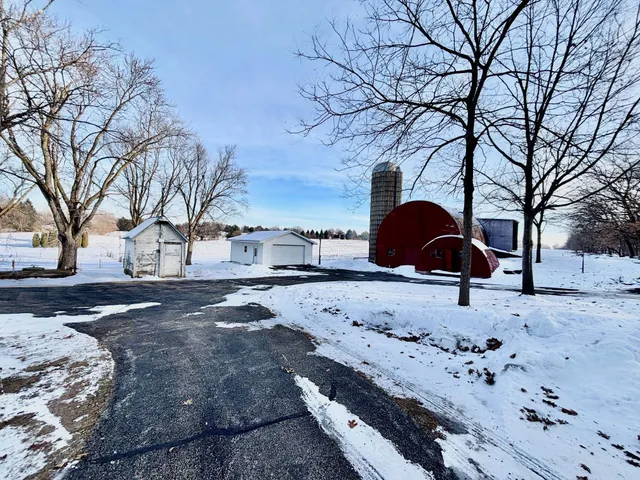 a wooden bench sitting in middle of a yard