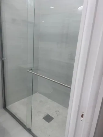 a bathroom with a glass shower door