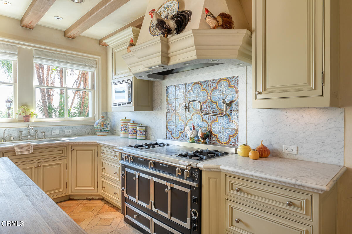 100 Los Altos Drive Pasadena, CA 91105 - Photo 18 of 72 a kitchen with stainless steel appliances granite countertop a stove and a sink