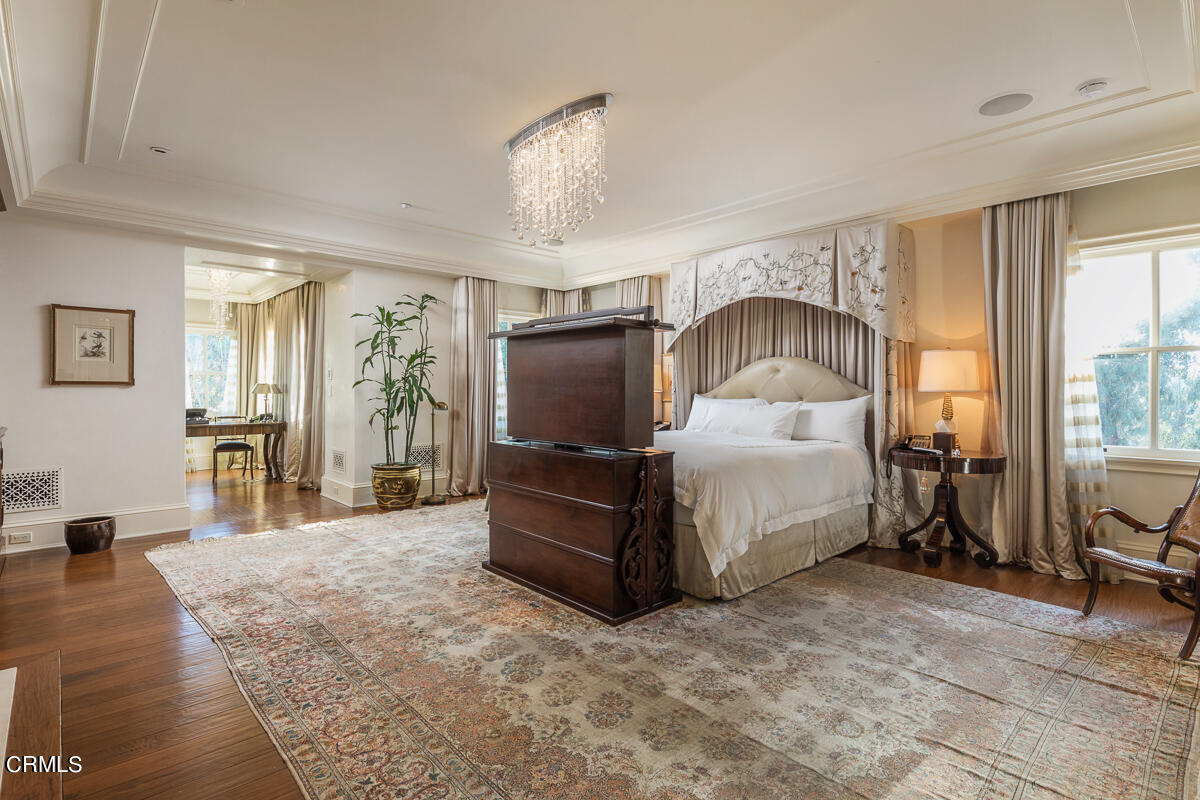 100 Los Altos Drive Pasadena, CA 91105 - Photo 34 of 72 a bedroom with a bed and a chandelier